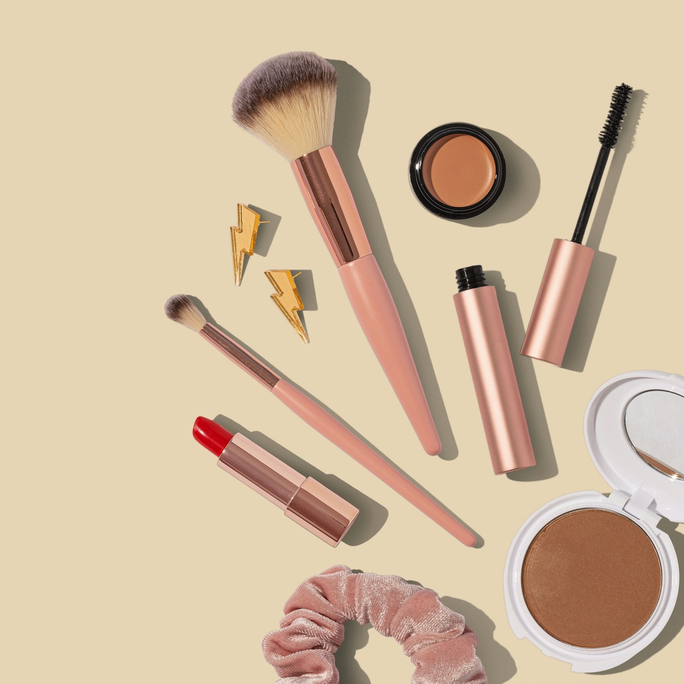 Everyday makeup brushes arranged on a vanity while a woman gets ready