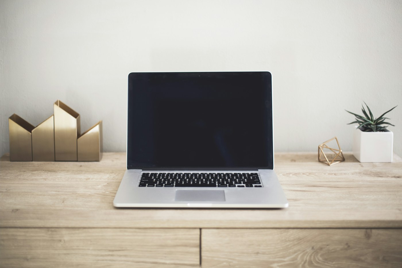 Hybrid worker connecting a USB-C hub to a laptop at a home desk
